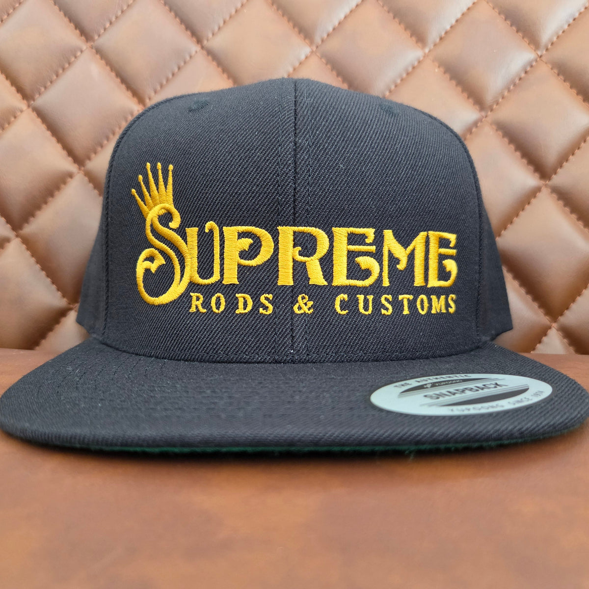 Black flat bill snap back with Hoodrich gold lettering