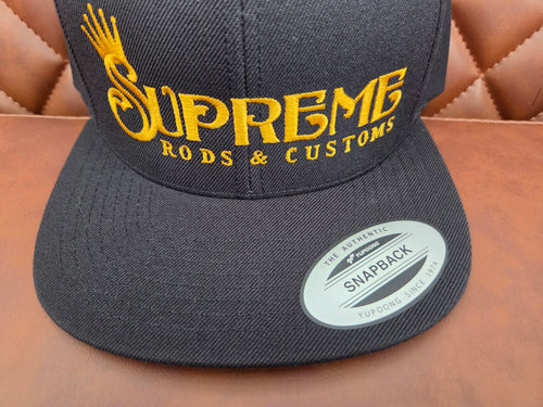 Black flat bill snap back with Hoodrich gold lettering